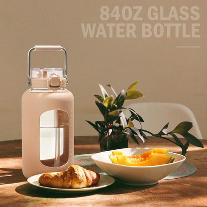BLUEGO 84oz Water Bottle Glass with Stainless Steel Handle Large 2.5l Water Bottle with Time Markers and Silicone Sleeve Half Gallon Water Jug BPA Free for Gym Daily Use, Amber